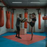 Woman Doing High Kick During Boxing Training